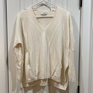 Babaton Aritzia Cream V-Neck Sweater with pockets.